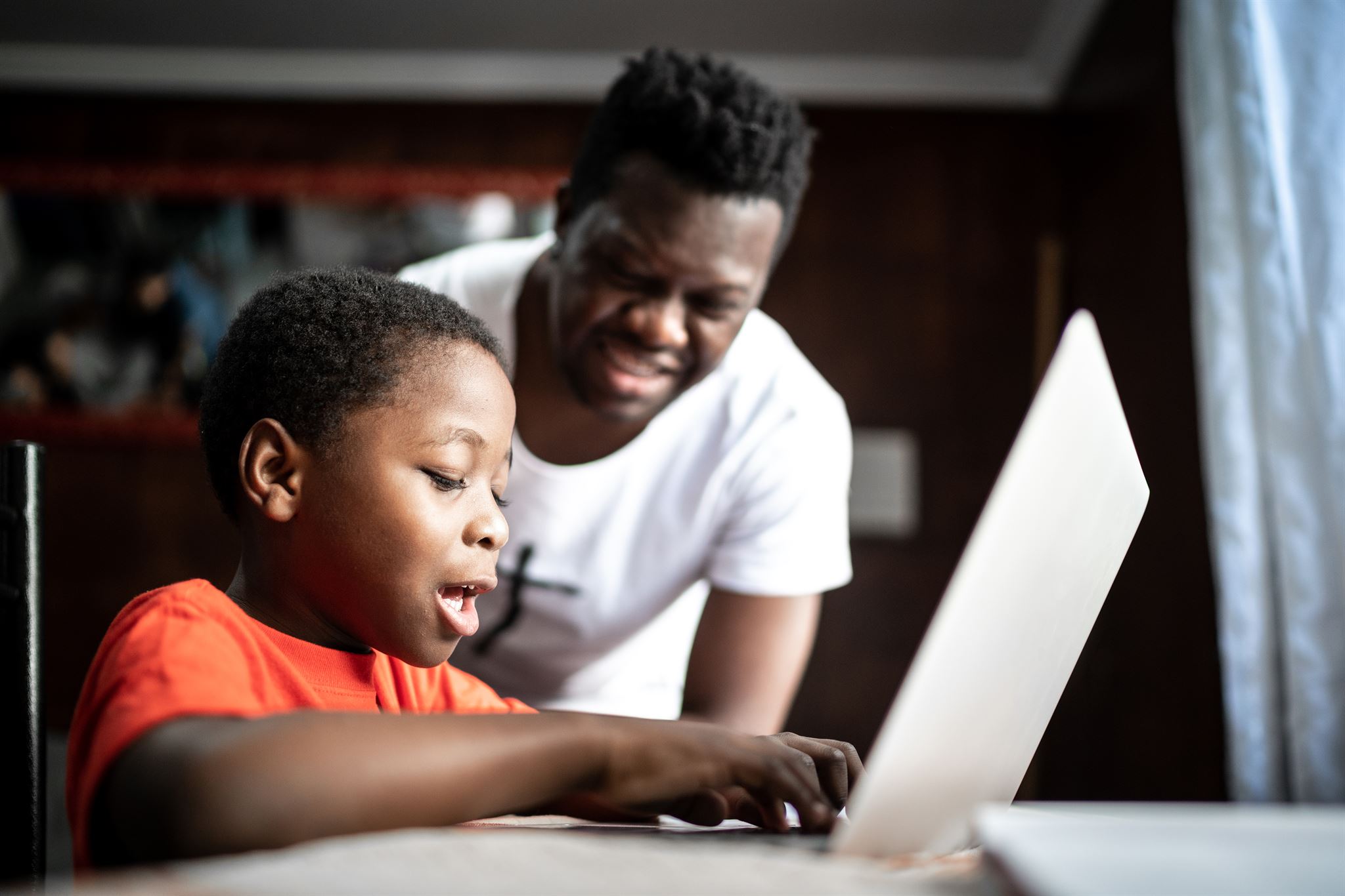 Man-and-boy-using-laptop